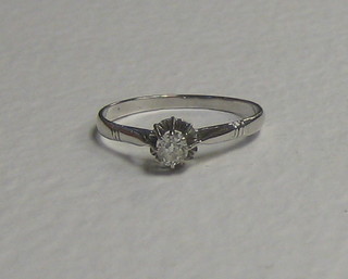 A lady's white gold solitaire diamond set dress ring