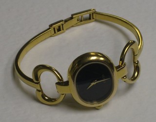 A lady's Gucci wristwatch contained in a gilt metal case, the reverse marked 1800