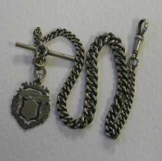 A silver curb link watch chain hung a medallion 11"