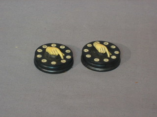 A pair of ebony and ivory circular scorers in the form of hands
