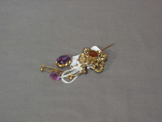 An amethyst coloured stick pin, do. brooch, do. ring together with a gilt metal brooch