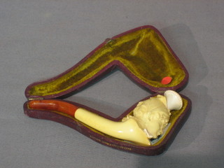 A carved ivory and amber cheroot holder in the form of a head