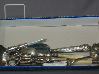 A pair of silver plated grape scissors and other silver plated flatware