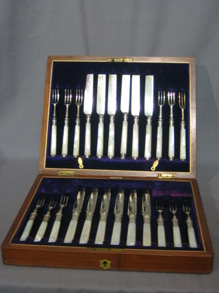 A set of silver plated fruit knives and forks with mother of pearl handles  contained in a walnut canteen box