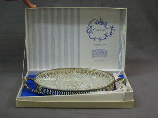 An oval pierced silver plated twin handled hors d'eouvres tray fitted 5 glass trays