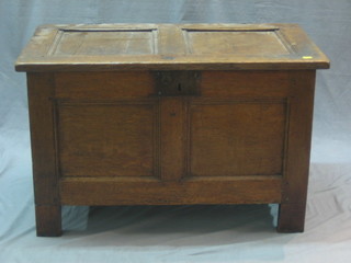 An 18th/19th Century oak coffer with hinged lid of panelled construction and with iron lock 33"