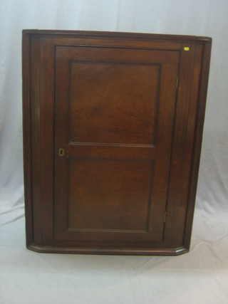 An 18th/19th Century oak corner cabinet enclosed by a panelled door 38"