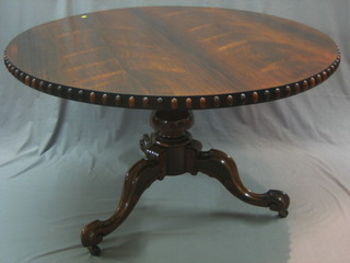 A handsome William IV circular rosewood snap top breakfast table with bead work border, raised on pillar and tripod supports 49"