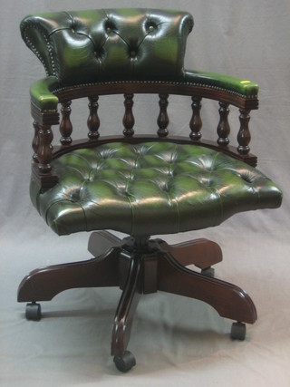A Victorian style mahogany framed office chair upholstered in green leather