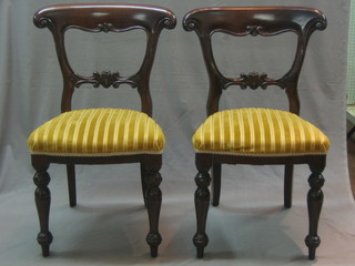 A set of 8 mahogany bar back dining chairs with shaped mid rails and upholstered seats, raised on turned supports