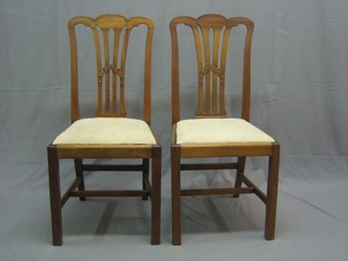 A set of 6 19th Century mahogany Hepplewhite style dining chairs with pierced vase shaped backs and upholstered drop in seats, raised on square supports united by H framed stretcher by Shoolbred