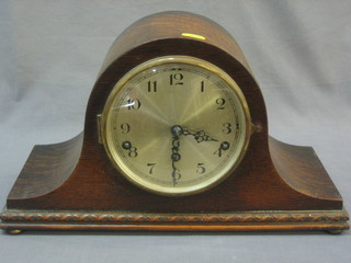 A chiming clock with silvered dial and Arabic numerals contained in an oak arch shaped Admirals hat case