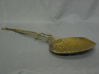 A 19th Century pierced brass cream skimmer with turned handle