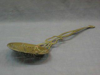 A 19th Century circular pierced brass cream skimmer