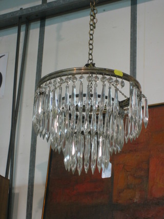 A circular glass 3 tier electrolier hung glass lozenges 