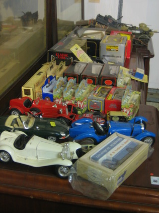 A collection of various toy cars and model tanks etc