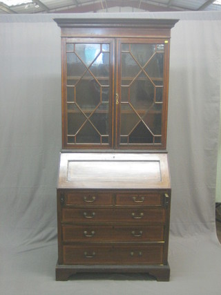 An Edwardian inlaid mahogany bureau bookcase, the upper section with moulded cornice, the interior fitted adjustable shelves enclosed by astragal glazed door, the fall front revealing a well fitted interior above 2 short and 3 long graduated drawers, raised on bracket feet 36"