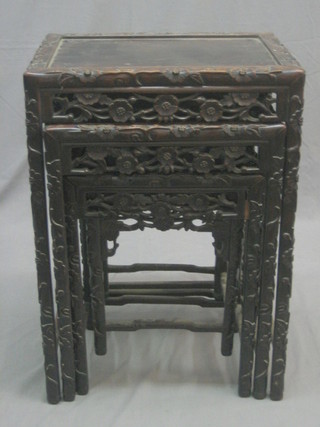 A nest of 4 Oriental pierced and carved Padouk coffee tables