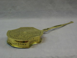 A shaped pierced brass chestnut roaster, the embossed hinged lid with armorial decoration