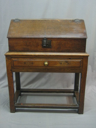 An 18th Century oak bible box with hinged lid raised on a later stand, the base fitted a drawer with block stretcher 28"