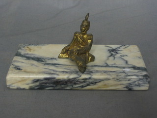 A gilt metal paperweight in the form of a seated Cavalryman, raised on a marble base 6 1/2"