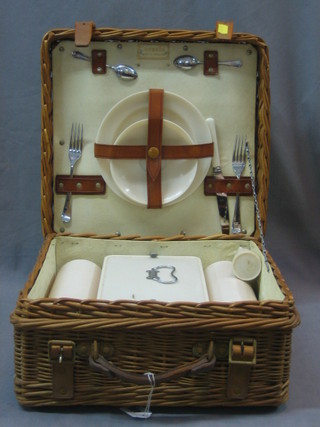 A 1950's Corracle picnic hamper with plastic Thermos flask etc inside