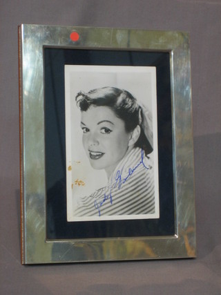 A signed black and white photograph of Judy Garland 5 1/2" x 3 1/2" contained in a modern silver easel photograph frame