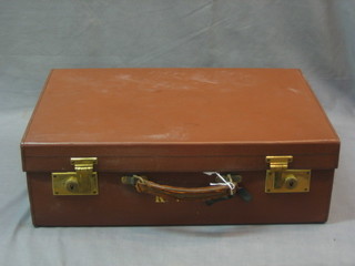 A leather suitcase with brass fittings