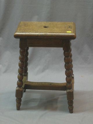 A 19th Century rectangular elm joyned stool, raised on bobbin turned supports with H framed stretcher 13"