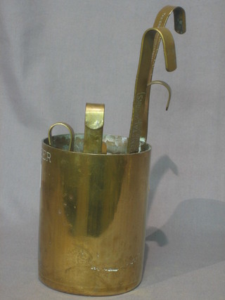 A set of 7 graduated brass measures marked The Original Metal Pressing Works Bombay,