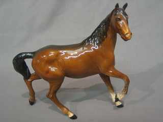 A Beswick figure of a prancing bay horse with front left hoof crooked, 8"