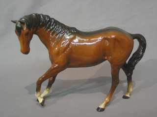 A Beswick figure of a prancing bay horse with left hoof crooked, 7"