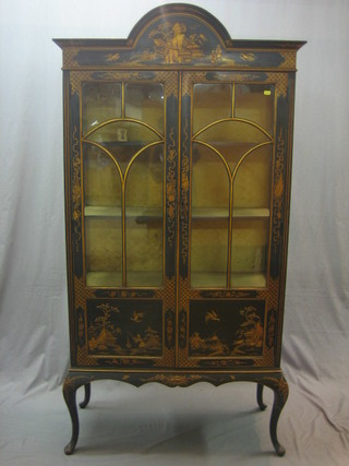 A 1920's black lacquered chinoiserie style display cabinet, the interior fitted shelves enclosed by panelled doors, raised on cabriole supports 36"