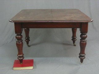 A Victorian mahogany extending dining table raised on turned supports 42"