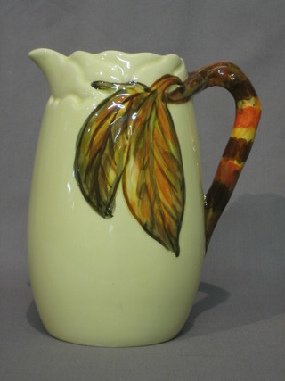 A Clarice Cliff pottery jug with stylised leaf shaped handle 9"