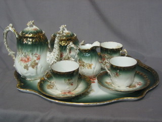 A French porcelain cabaret set comprising tray, coffee pot, sucrier, cream jug and 3 cups and saucers