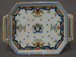 A faience muffin shaped twin handled tray with armorial decoration, the reverse marked H anchor D 117 12"