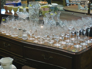 A cut glass water jug, do. vase, a glass ice bucket, 8 cut glass long stemmed hock glasses, 6 cut glass sherry glasses etc