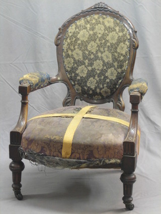 An Edwardian walnut open arm chair, raised on turned supports