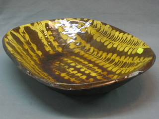 An oval brown glazed pottery bowl 16"