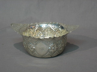 A Victorian embossed silver twin handled bowl, London 1890 (marks rubbed) 4 ozs