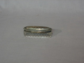 An oval pin jar with silver lid