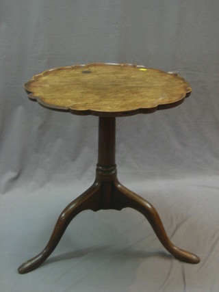 A 19th Century circular mahogany wine table with pie crust edge raised on pillar and tripod supports, 21" (some damage to beading on edge)