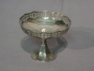 A circular silver comport with pierced border, raised on an outswept foot, Birmingham 1912, 2 ozs
