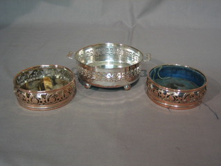 A pair of silver plated pierced bottle coasters 4 1/2"  and a circular pierced silver plated dish frame