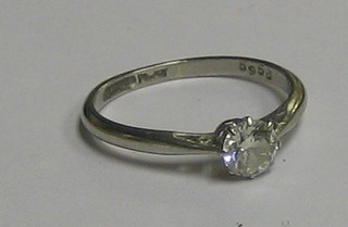 An 18ct white gold or "platinum" dress ring set a solitaire diamond