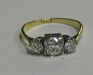 A lady's 18ct white gold or platinum dress ring set a square cushion cut diamond supported 2 diamonds