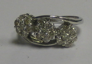 A lady's 18ct white gold 3 stone cluster ring surrounded by numerous diamonds