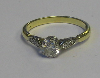 A lady's 18ct yellow gold engagement ring set a solitaire diamond and 6 diamonds to the shoulders