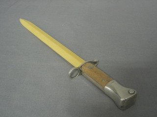 An ivory and silver mounted newspaper holder in the form of a Wilkinson's double edged bayonet with ivory blade, the silver mounts marked Regards Xmas 1895